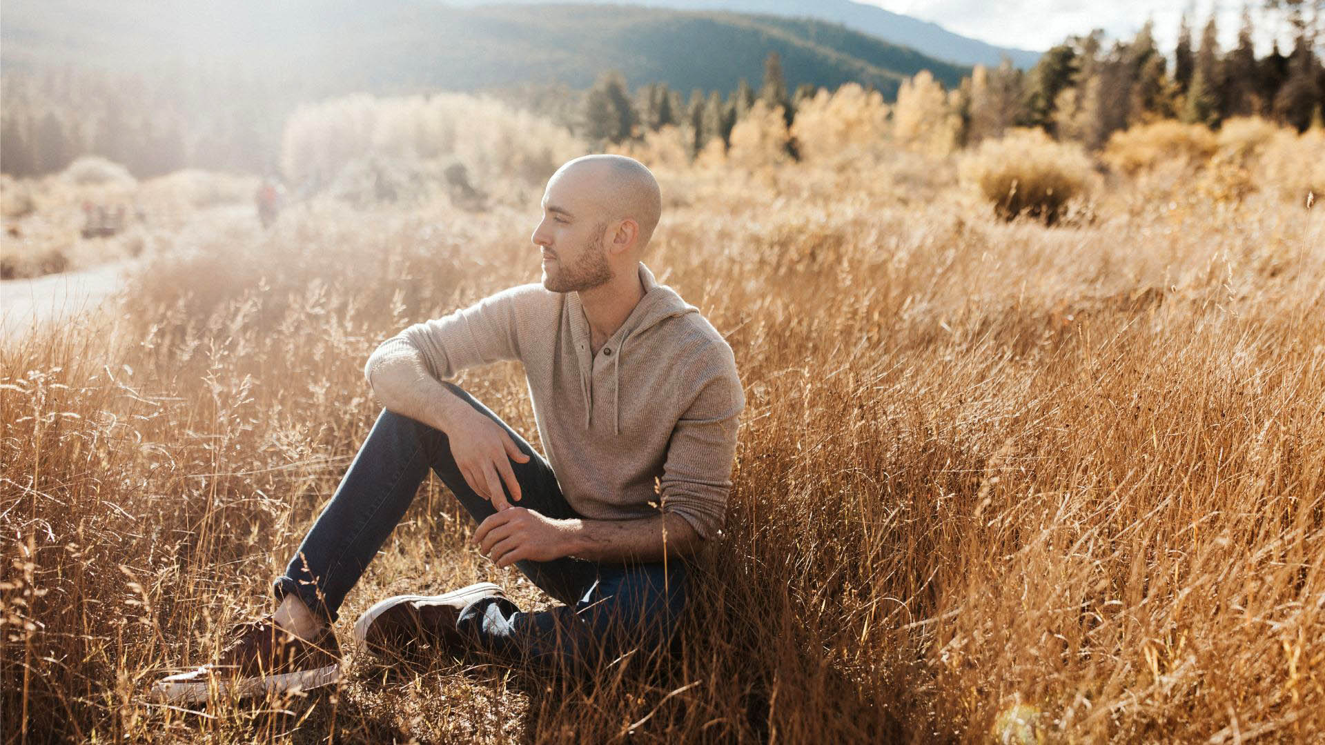 Jason sitting in a golden field